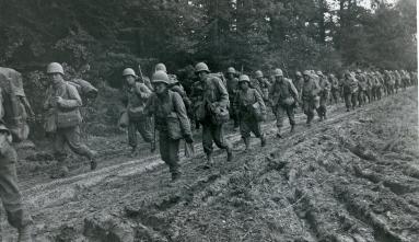 The 442nd soldiers march on a road in France